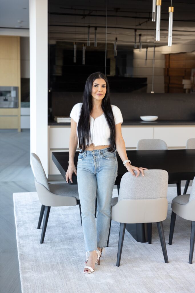 Asal Almawy standing in a modern dining room